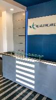 The reception table.

Being a pharmaceutical unit, we were asked not to use wood, plywood and other wood based material for the work. This table therefore has been made of stainless steel, glass and solid surfacing material.